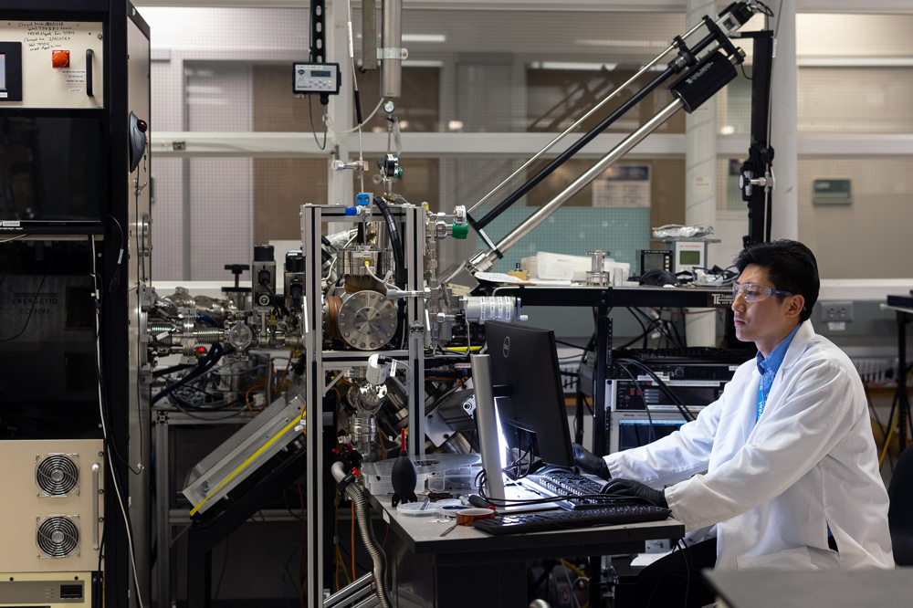 A student working on engineering equipment in a UAlbany lab.