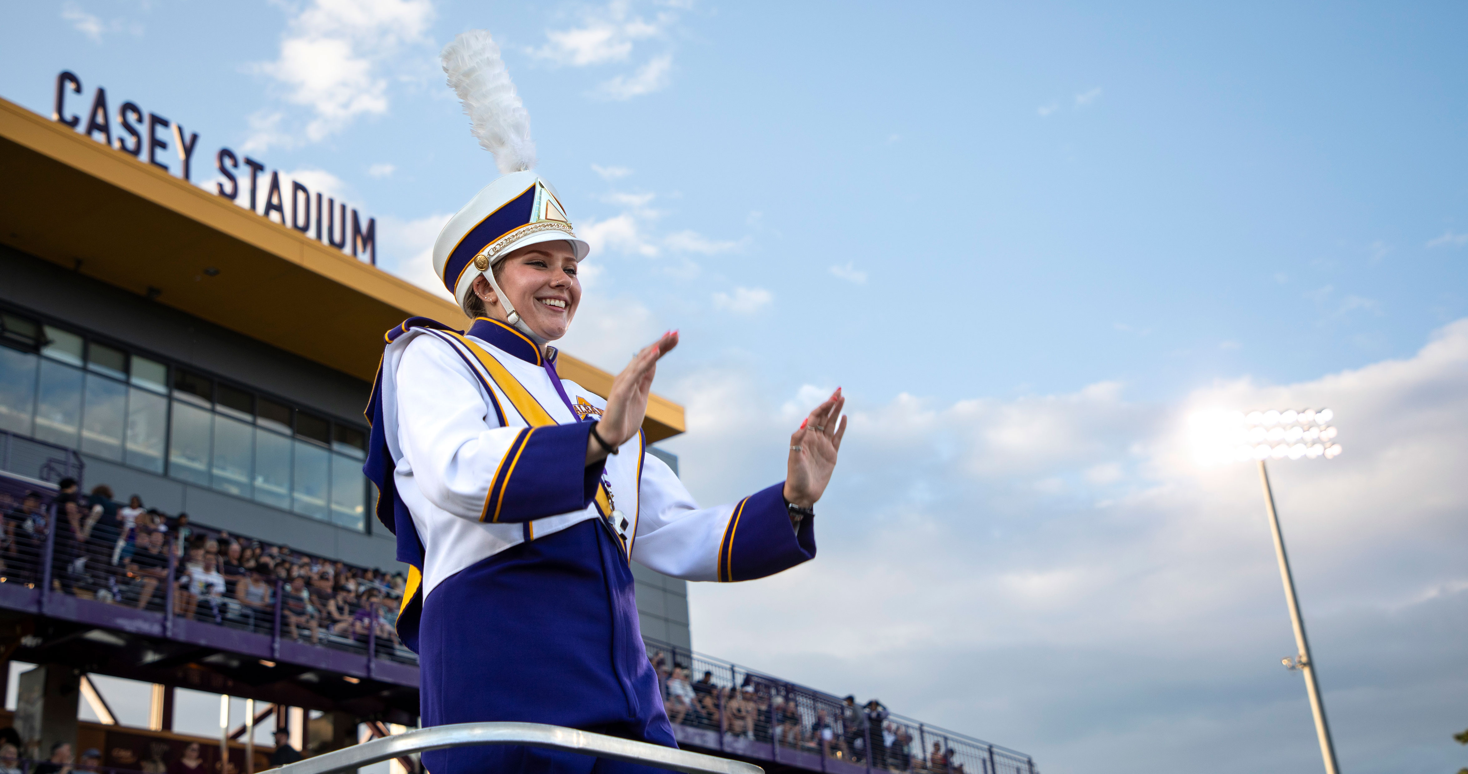The Marching Great Danes' drum major directs the band from a raised platform in Casey Stadium.