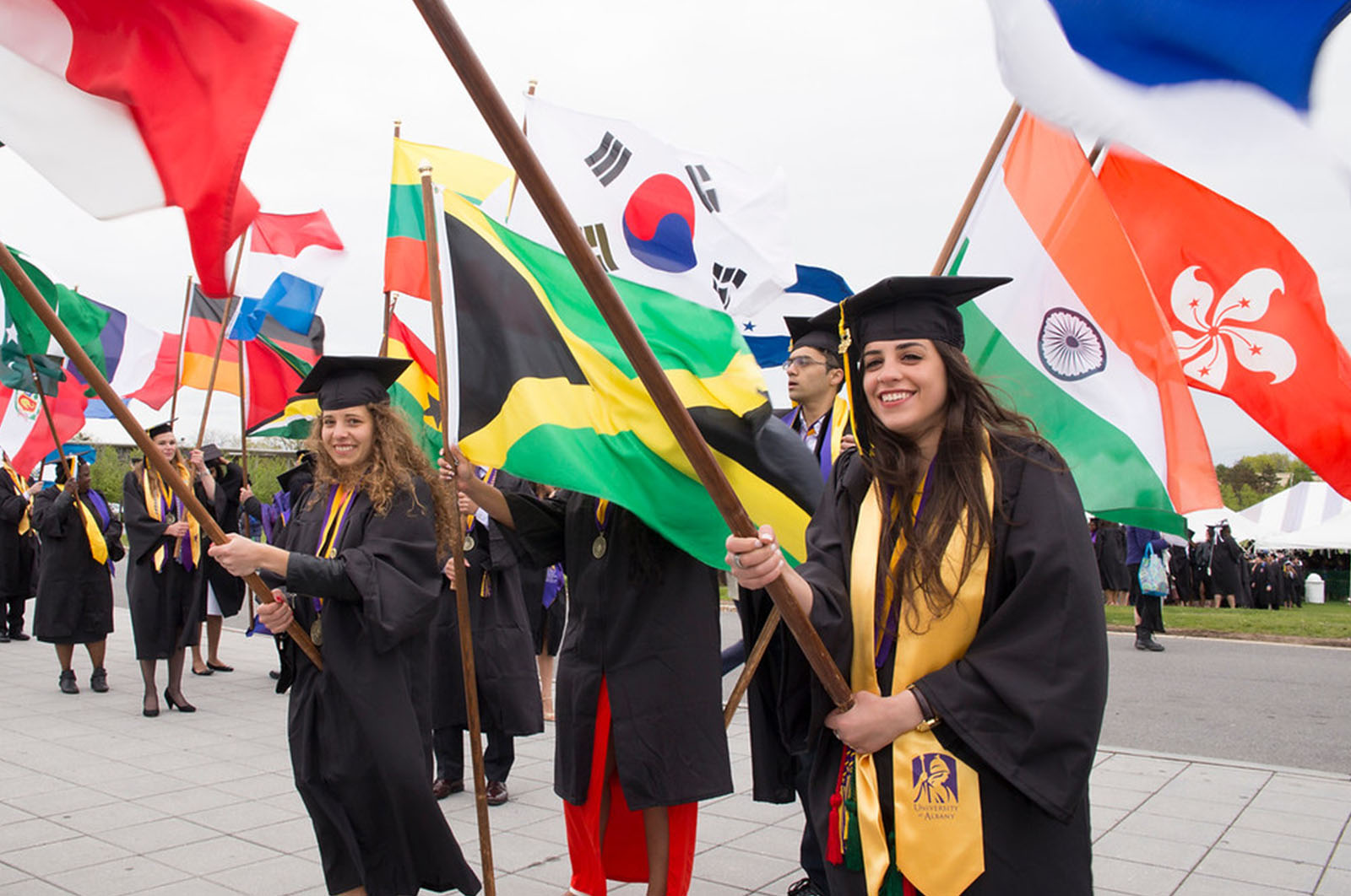 Students holding flags at commencement