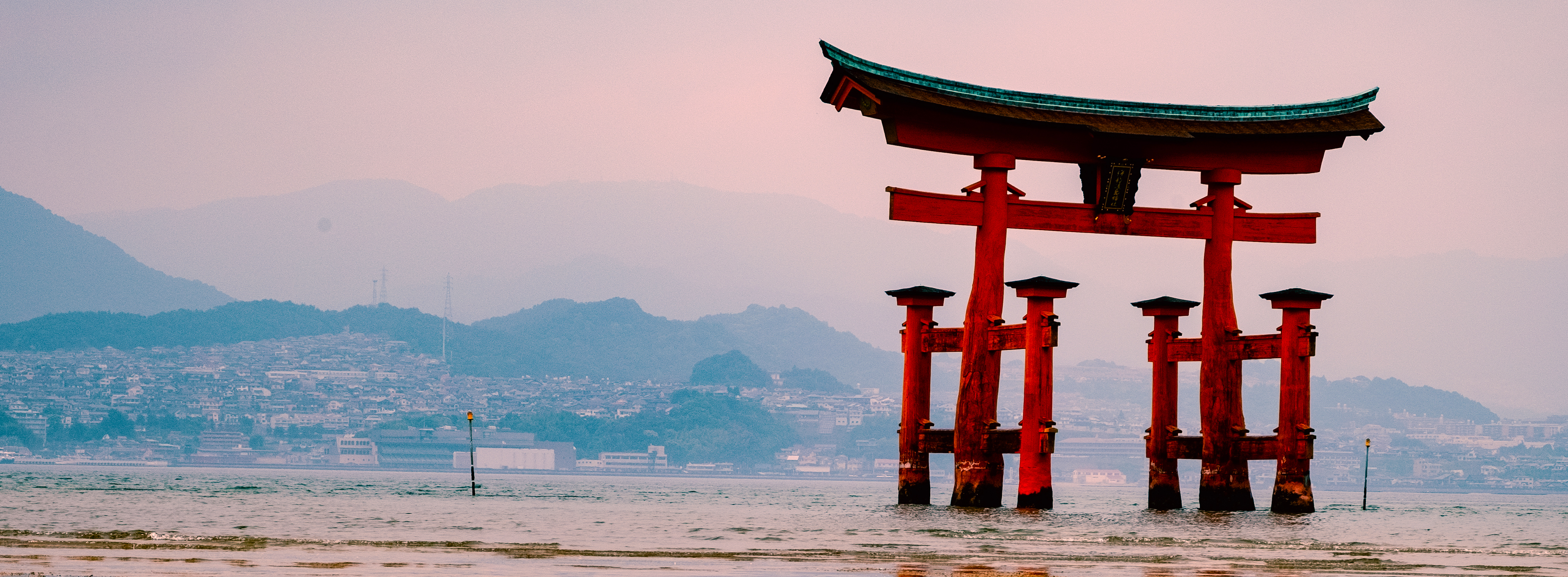 The red floating torii gate of the Itsukushima Shrine at low tide on Miyajima Island near Hiroshima.