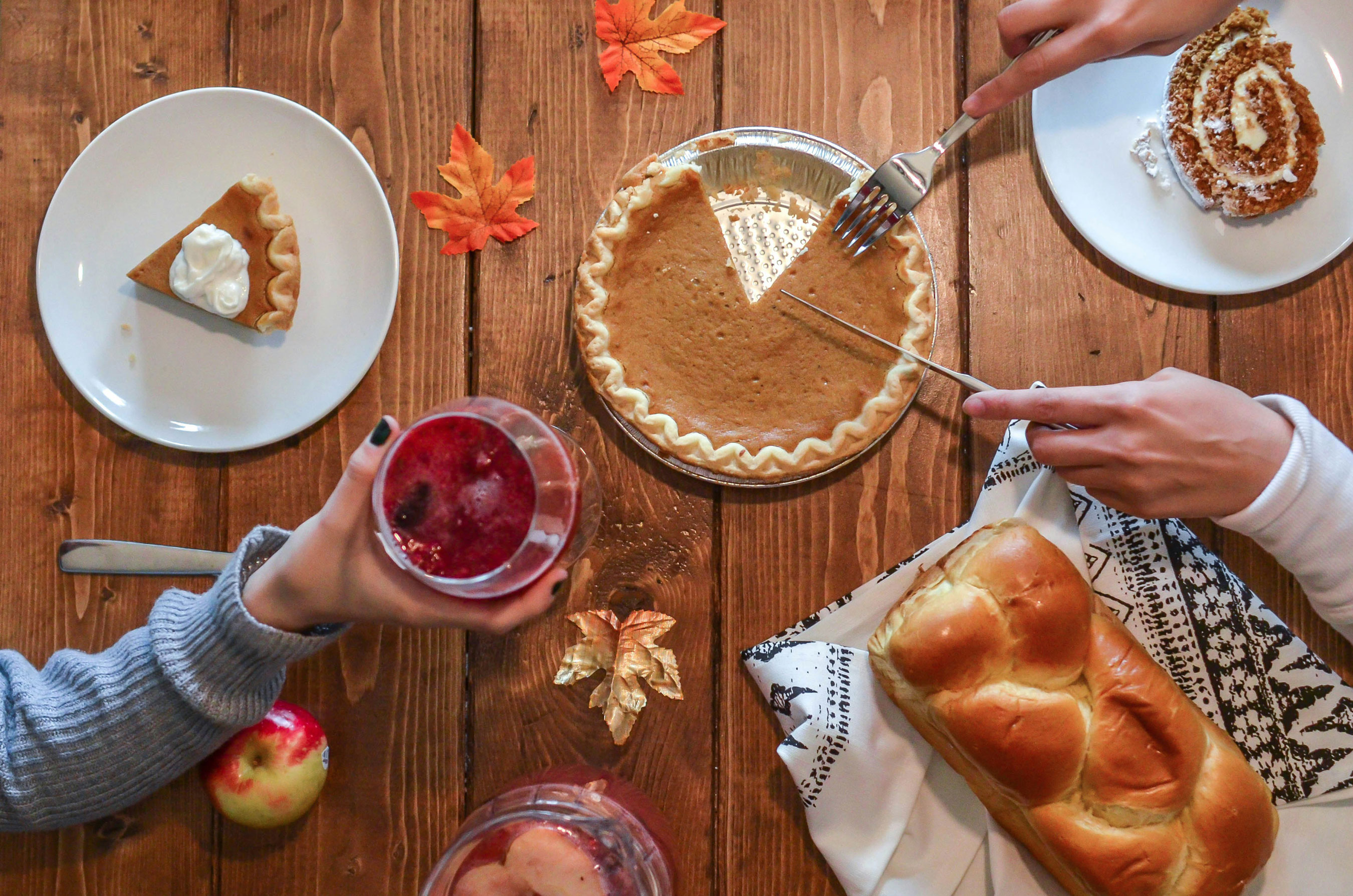 A table set with various plates of food and pies, showcasing a festive meal ready to be served.