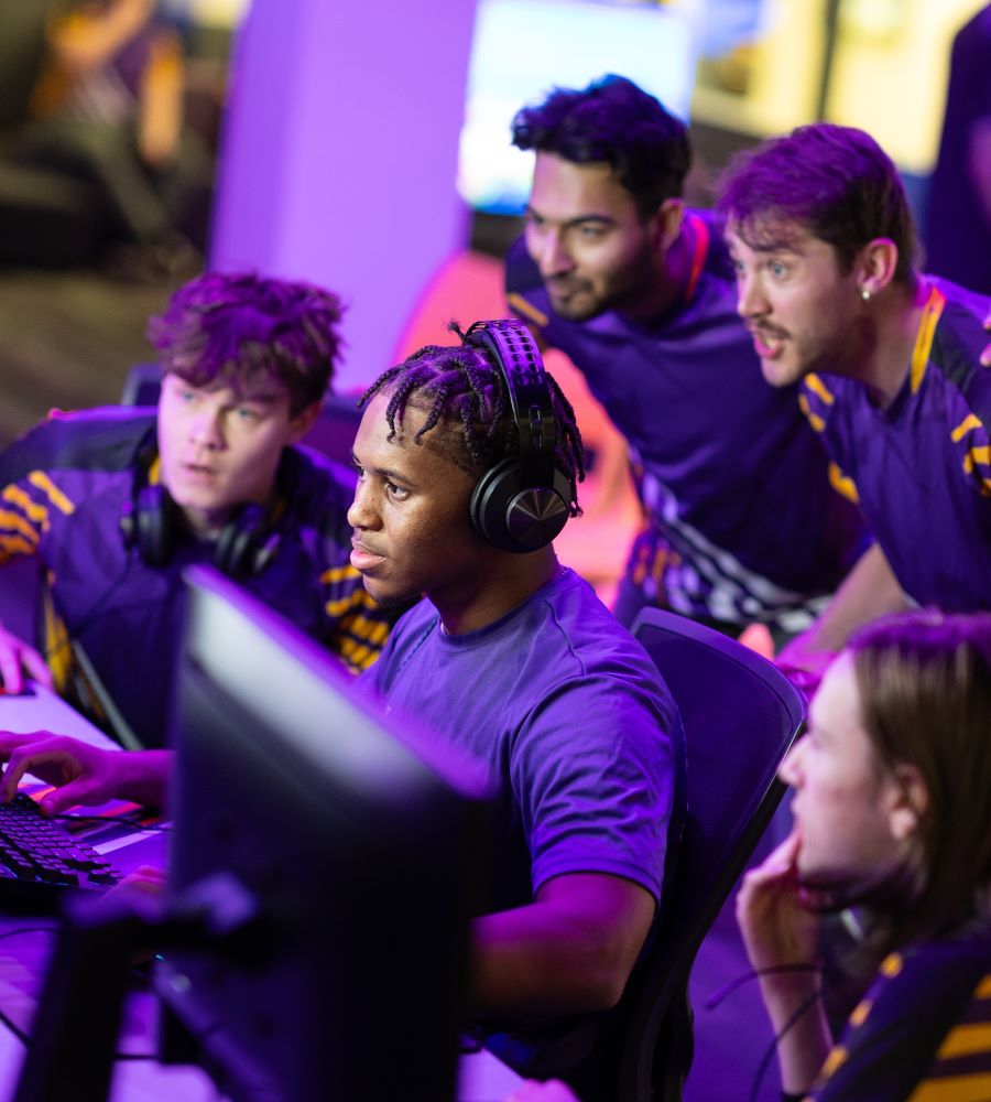 Esports team cheers on a player in competition.