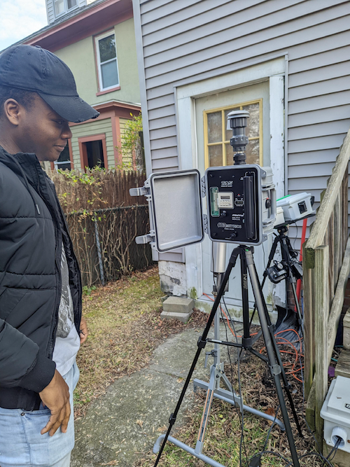 UAlbany undergraduate student Marco Eugene (Bio Undergrad) deploying low-cost sensors and mini-vol sampler to measure air quality in a residential neighborhood.
