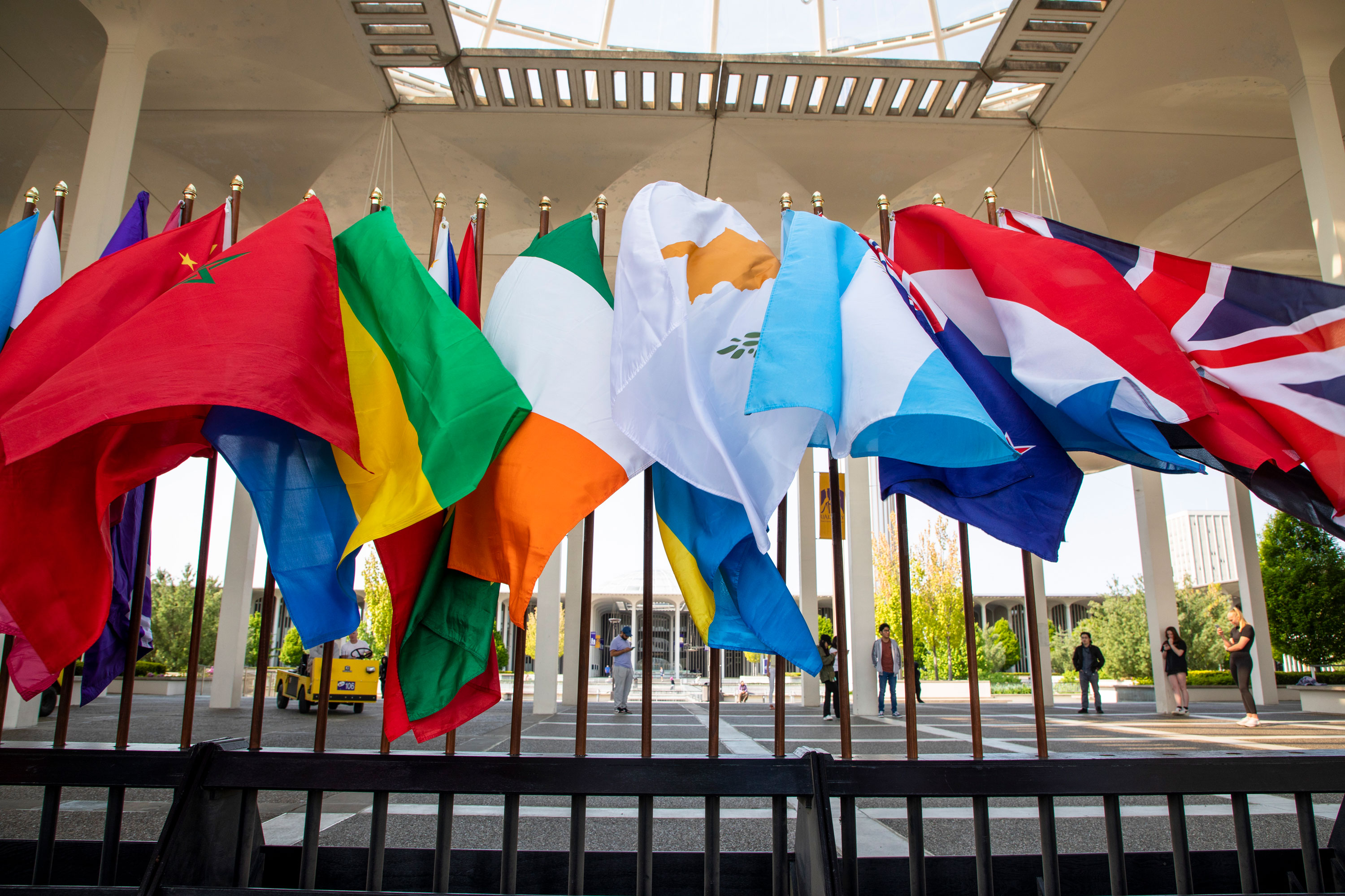 A line of international flags wave in the wind on the Academic Podium.