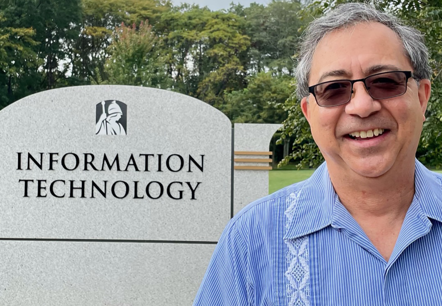Jim Bole CISO stands in front of Information Technology sign outside