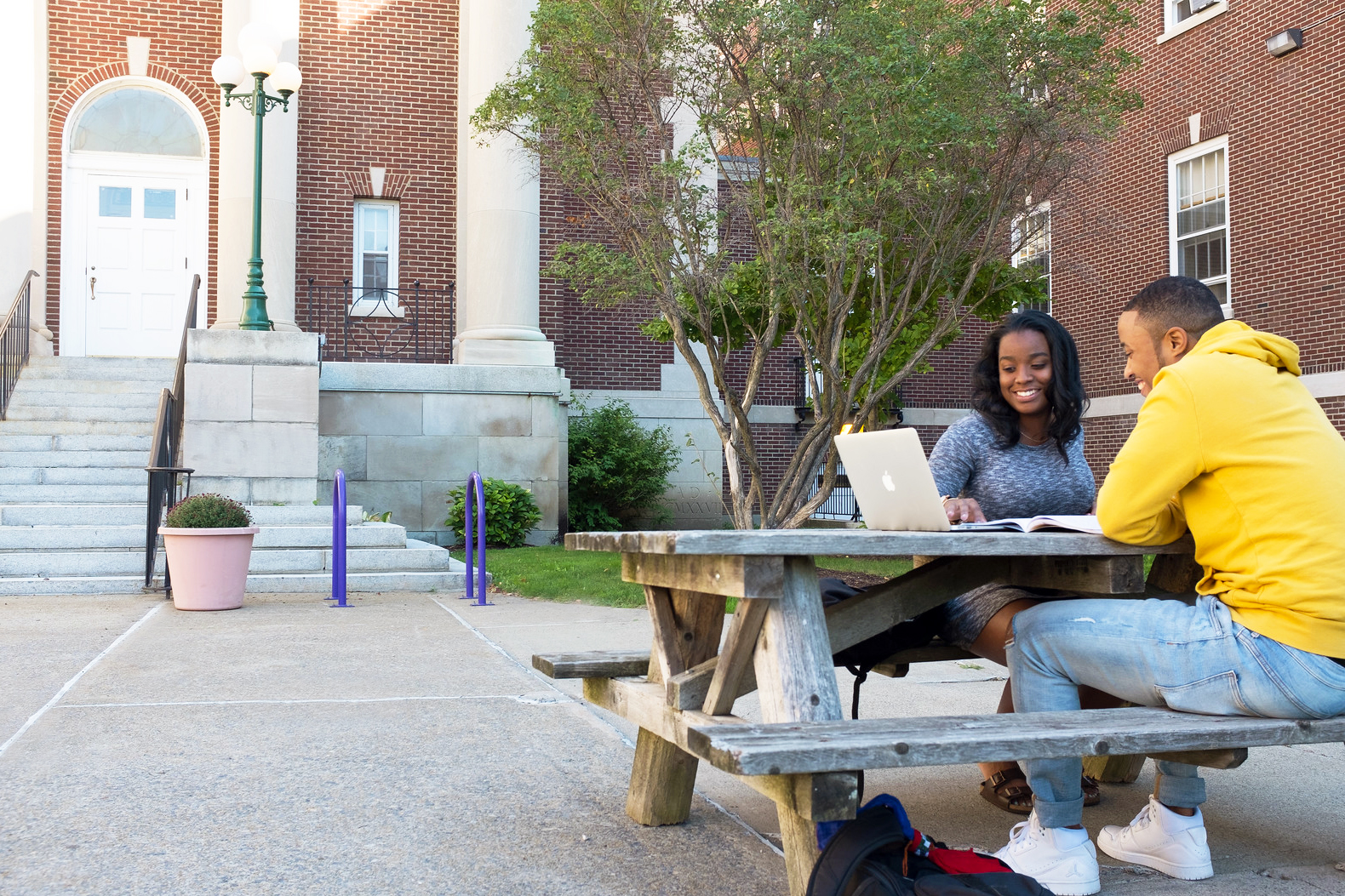 Two students studying in the Downtown Campus courtyard