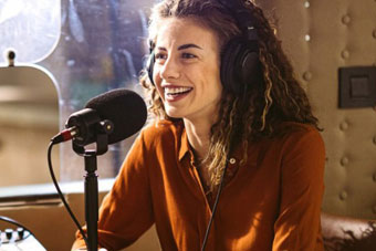 A public relations specialist answers questions at a press conference.