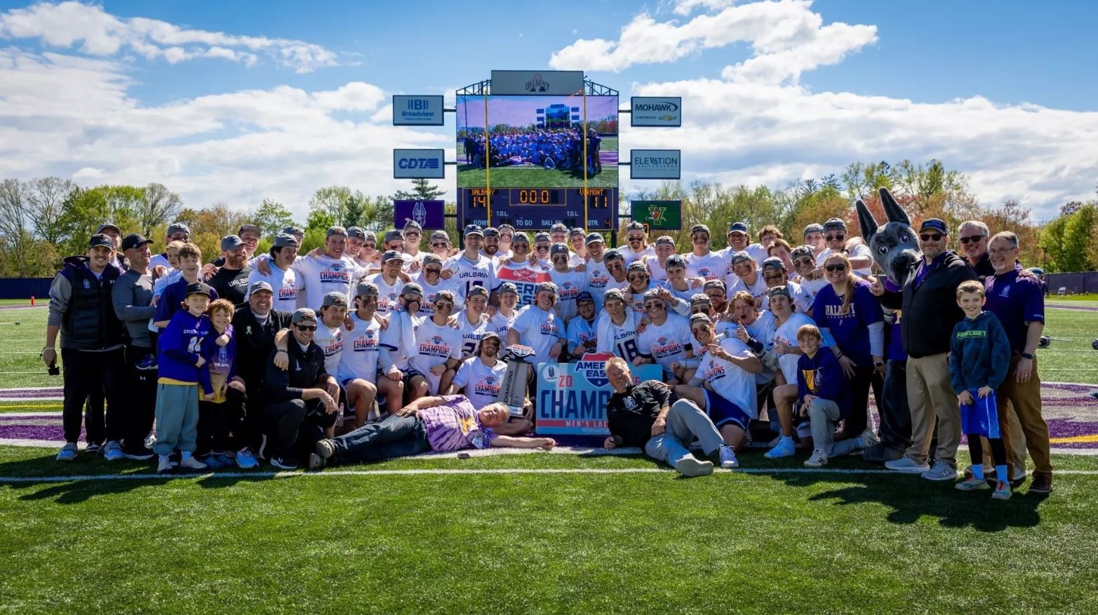 UAlbany's men's lacrosse team celebrates its America East Championship at Casey Stadium on Saturday.