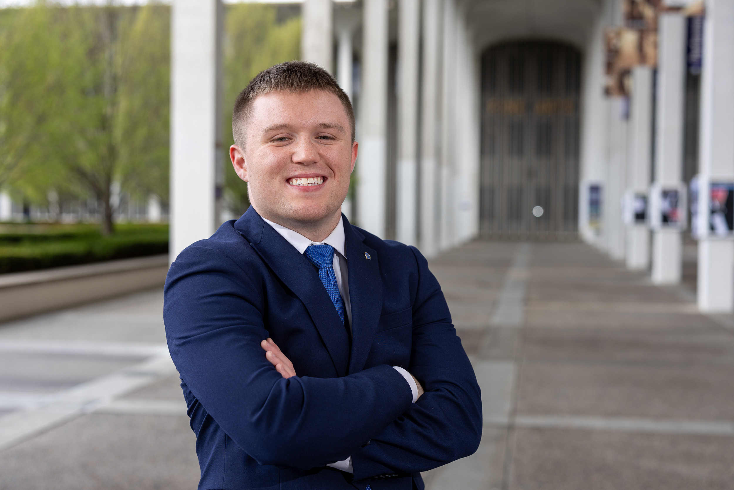 A portrait of UAlbany graduate Sean Millington on the main podium at UAlbany