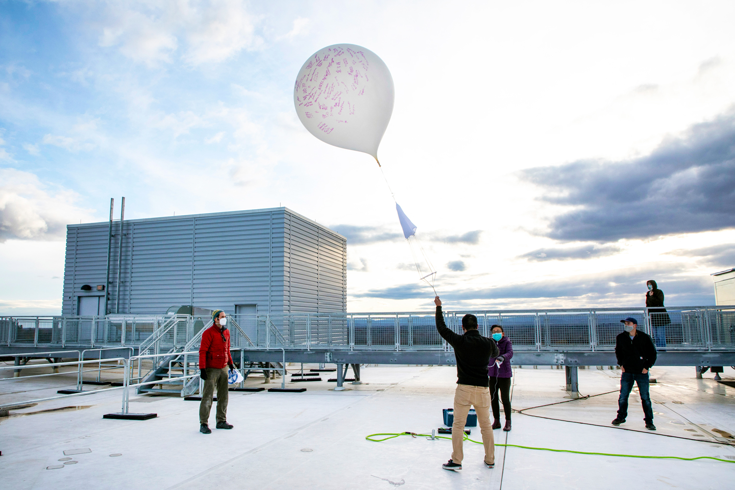 UAlbany researchers launch a weather balloon from the roof of the ETEC building.