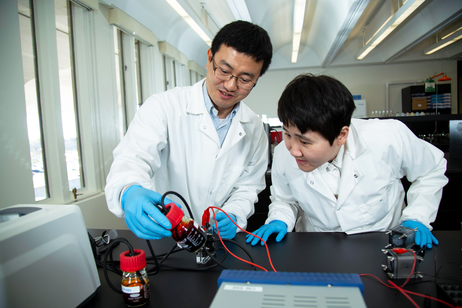 Two UAlbany researchers conducting an experiment in the Environmental and Sustainable Engineering biology lab.