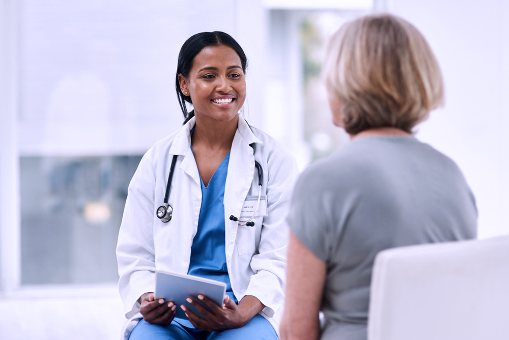 A health care professional conducting a consultation with a patient.