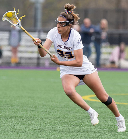 UAlbany lacrosse player Katie Pascale catches the ball in her lacrosse stick.