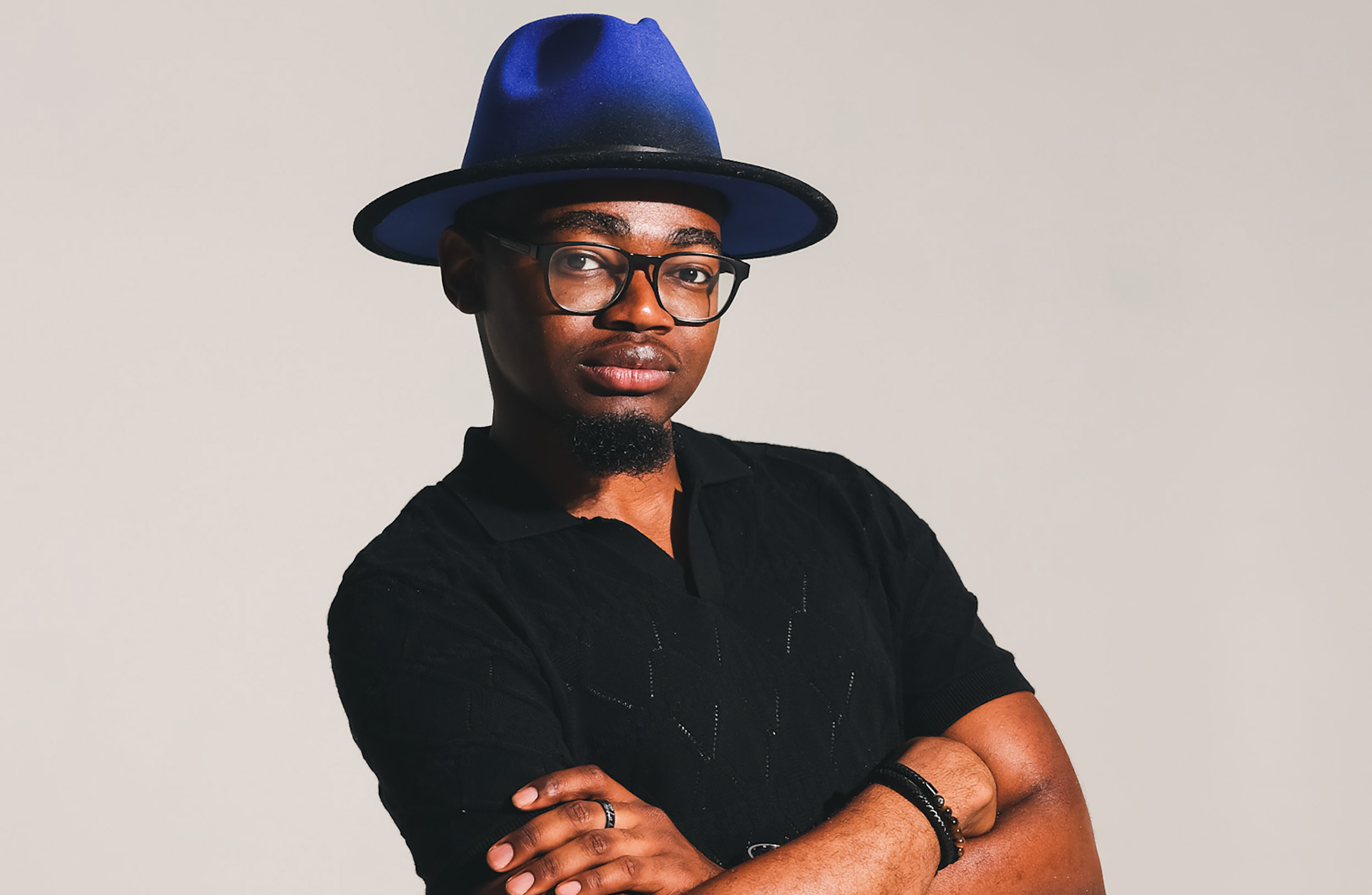 A potrait of UAlbany student Dominique Platt inside against a beige background