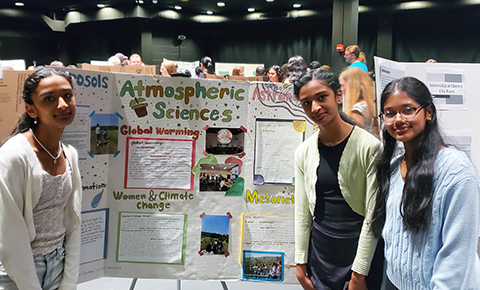 Three girls from Shaker High School in Loudonville NY present their poster at the 11th annual Girls Inc presentation at UAlbany in the Performing Arts Center.