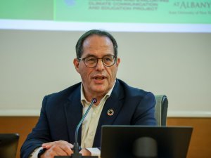 Dr. Aaron Benavot speaking at a conference