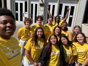 group of people in yellow t-shirts