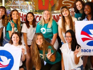 Students hold Peace Corps banners.