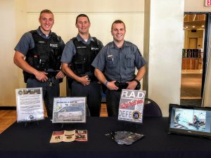 UPD Officers standing at RAD booth for students 