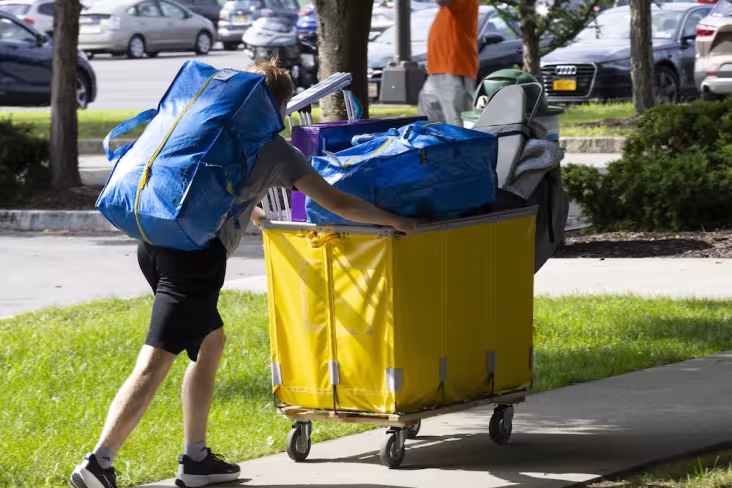 Student pushes a cart of belongings on Move-In Day.