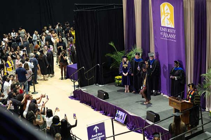 A student celebrating at stage crossing. 