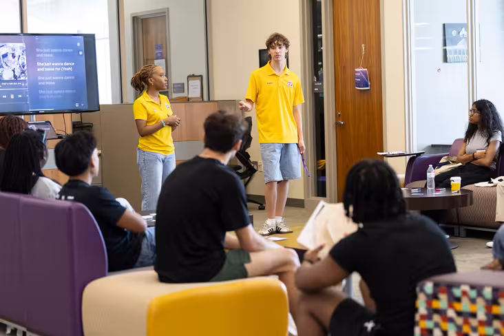 A pair of Orientation Leaders present to Orientation Attendees.