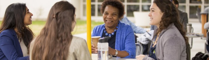 Professor Frankie Bailey meeting with students outside the Campus Center.