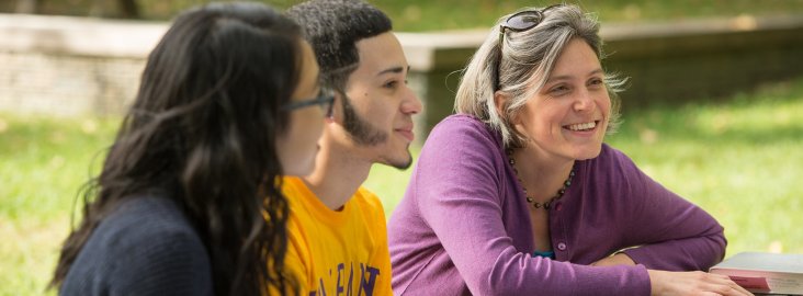 History professor having a discussion with students in the UAlbany azalea garden.