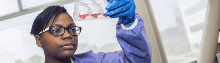 A student conducting research in a biology lab.