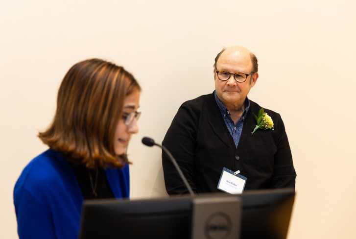 Economics Professor Ken Bulko listens while a student talks about his impact in the classroom at the FYE Annual Spark & Torch Awards Ceremony.
