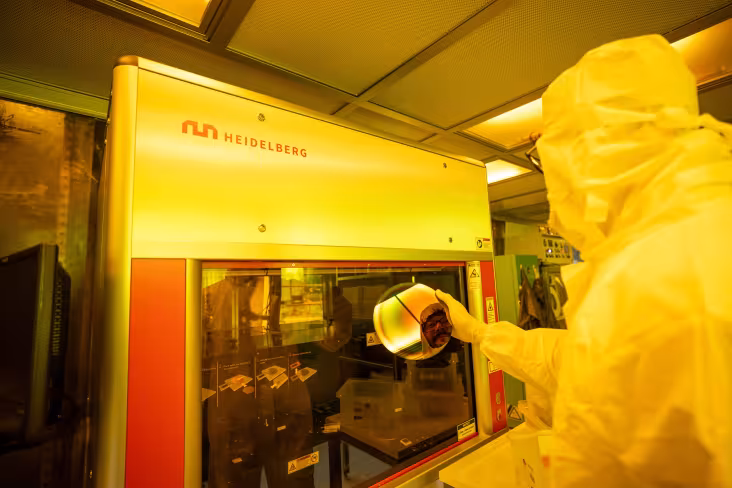 A researcher works inside a clean room at UAlbany.