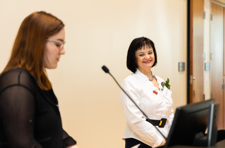 History Professor Camelia Lenart listens while a student talks about her impact in the classroom at the FYE Annual Spark & Torch Awards Ceremony.