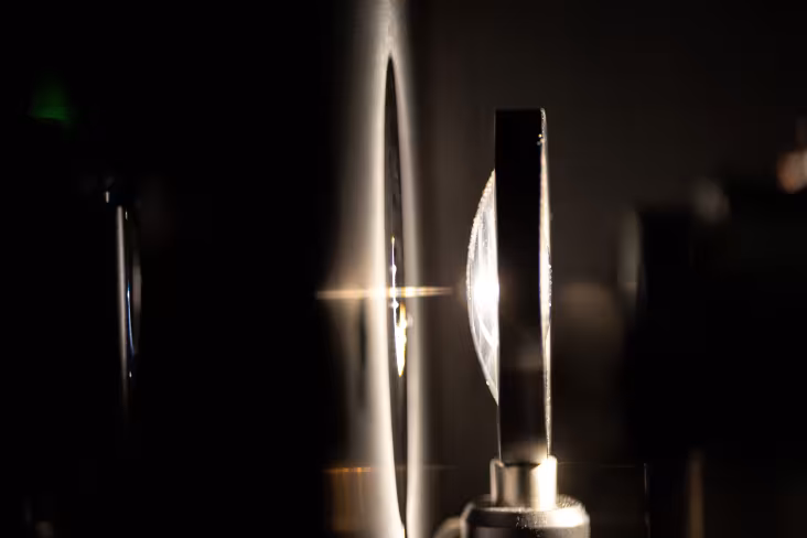 Equipment inside UAlbany's quantum photonic measurement lab is lit up in bright light.