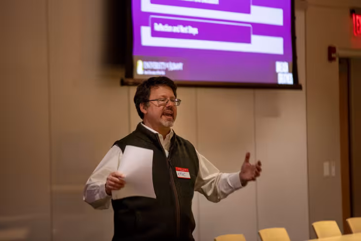 The AI Plus Institute’s Interim Director Eric Stern gestures while speaking at an event.