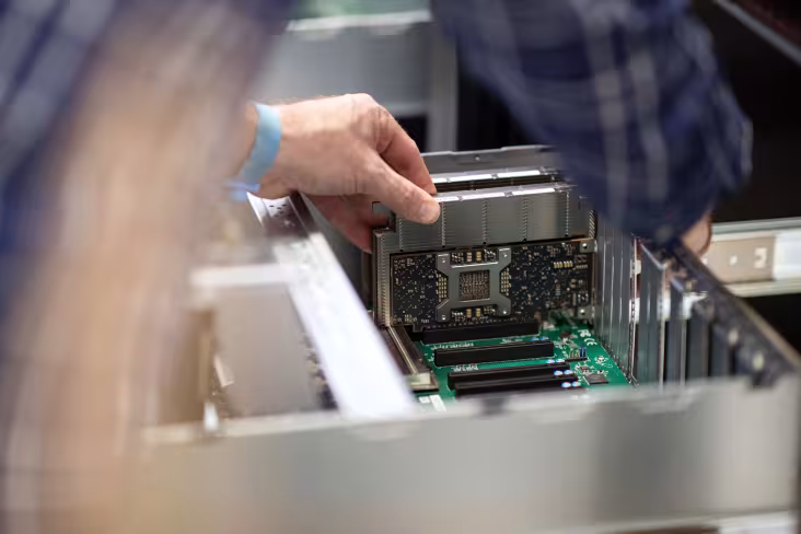 A technician installs the prototype IBM Artificial Intelligence Unit (AIU) cluster on the University at Albany campus.