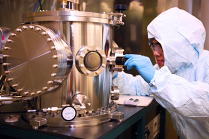 A UAlbany nanotechnology researcher working on equipment in a cleanroom.