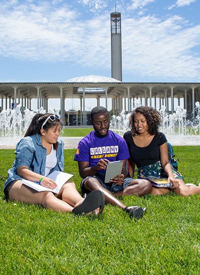 Students studying near a fountain