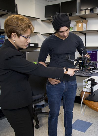 ECE Professor Dola Saha working in lab with student