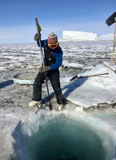 Amanda Andreas digs in ice in Antarctica. 