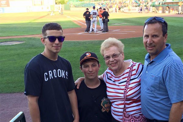 Luc as bat boy for the Long Island ducks with his family on the field
