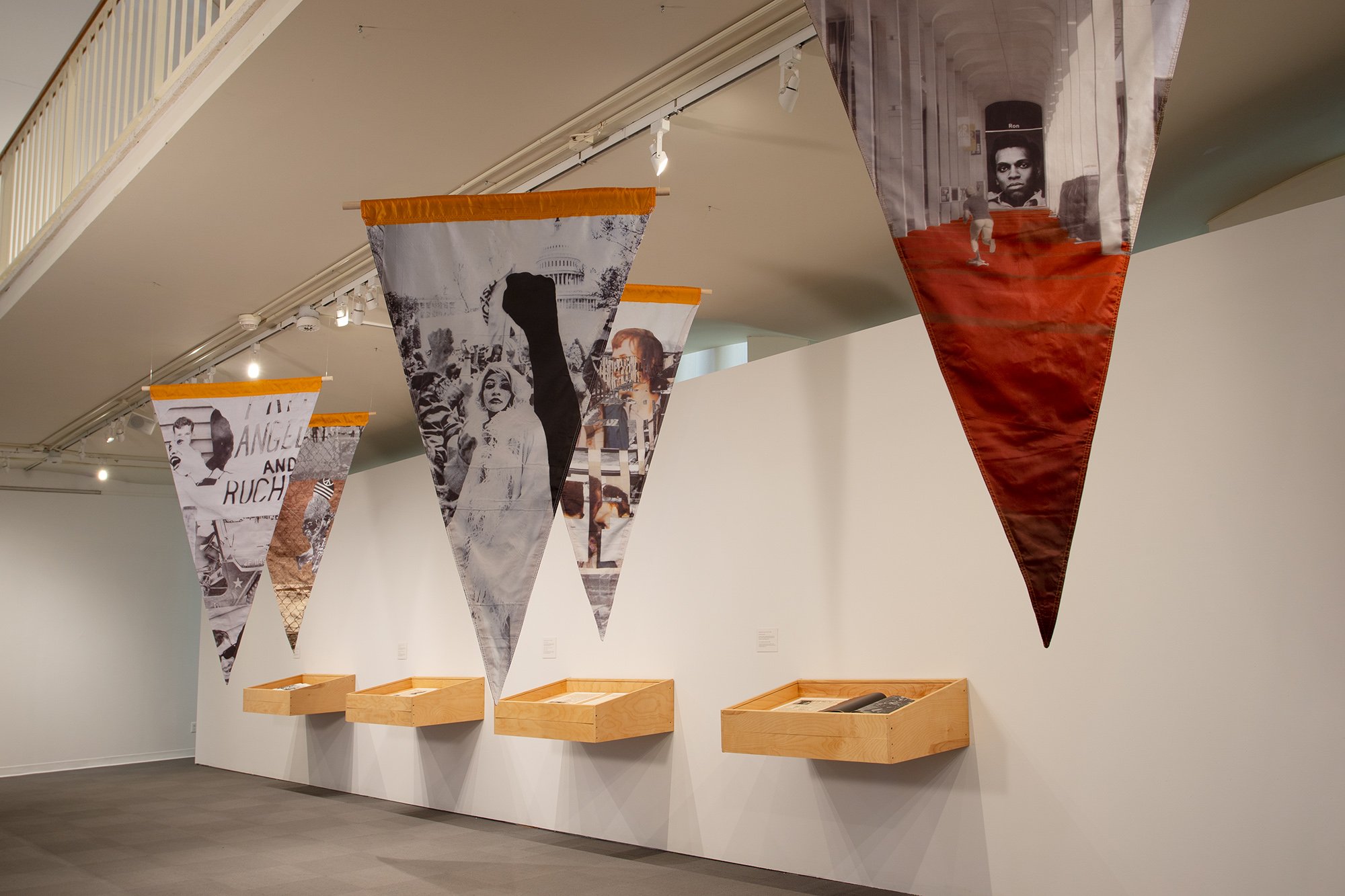 Pennants with collaged images and wooden vitrines