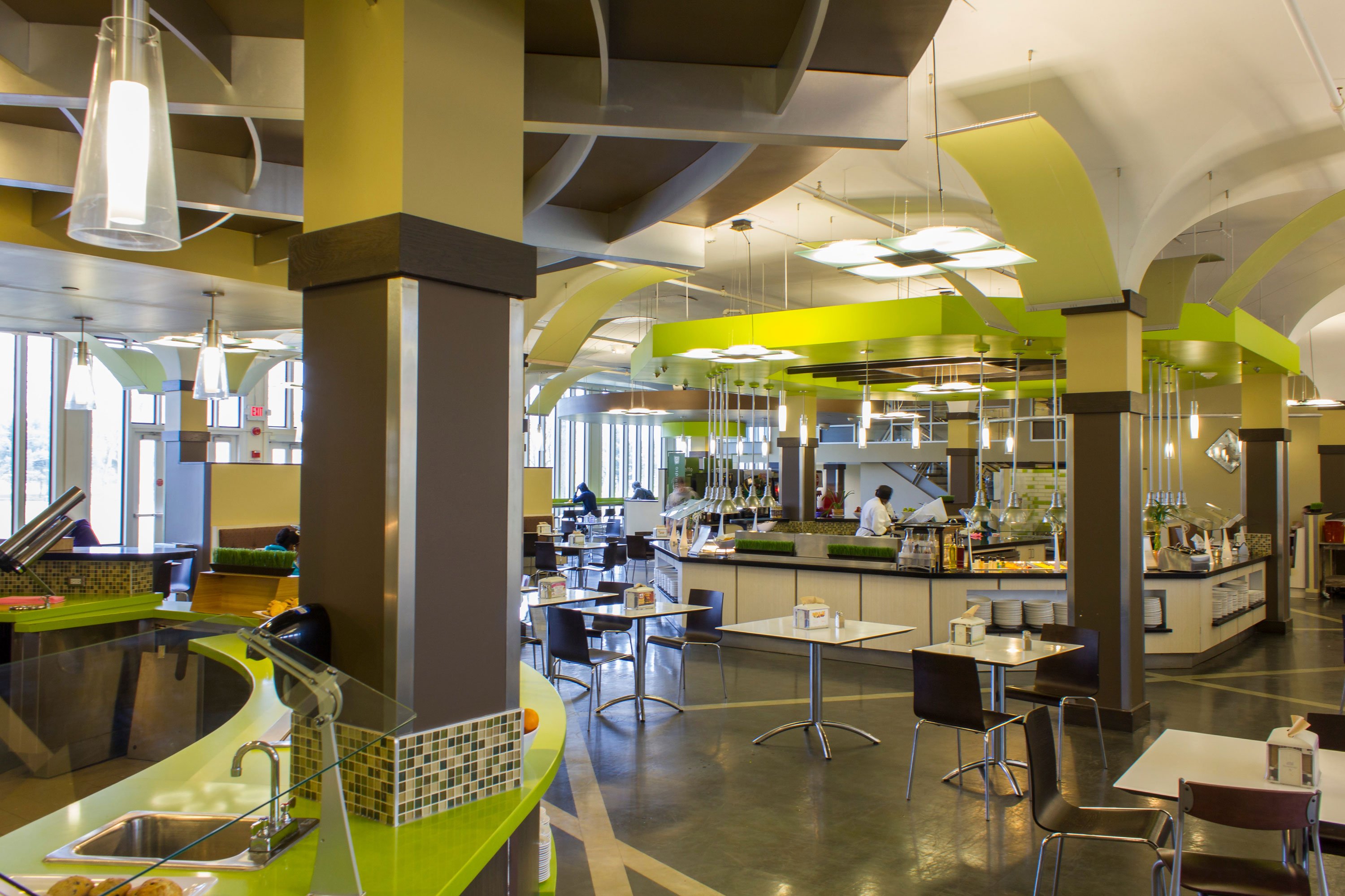 State Quad Dining Hall, with green walls, food stations, tables and chairs