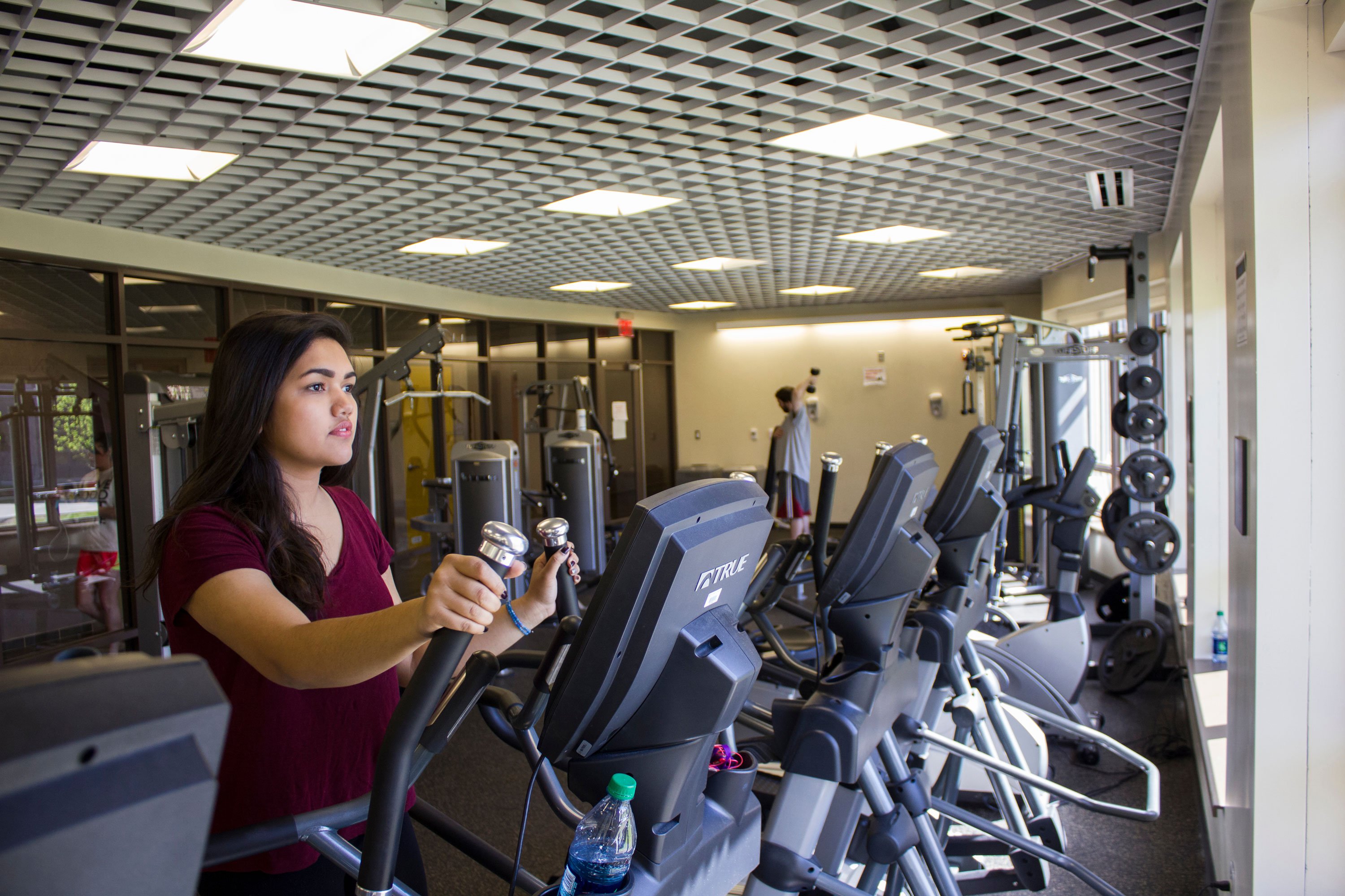 A student uses an elliptical machine inside the Liberty Terrace fitness center