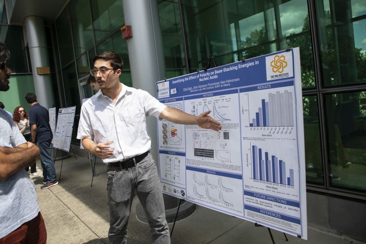 A student presents his research poster.