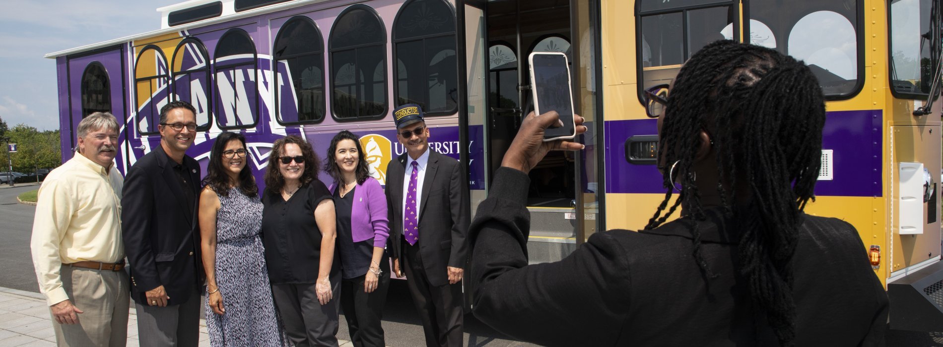 Members of the Executive Council in front of the UAlbany trolley