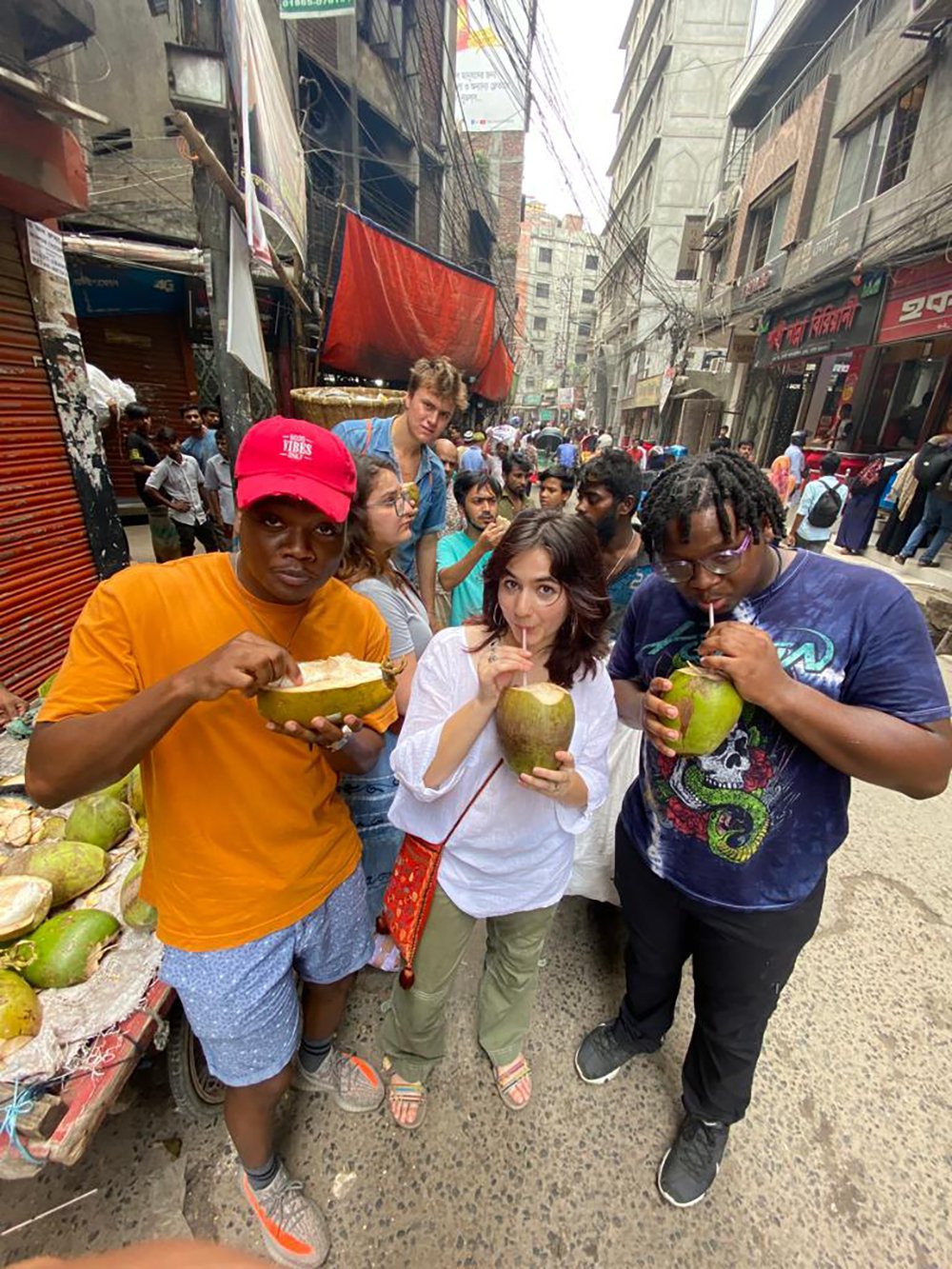 Marco Eugene, Sophie Bose and IShe Mawasha at a street vendor in Dhaka.