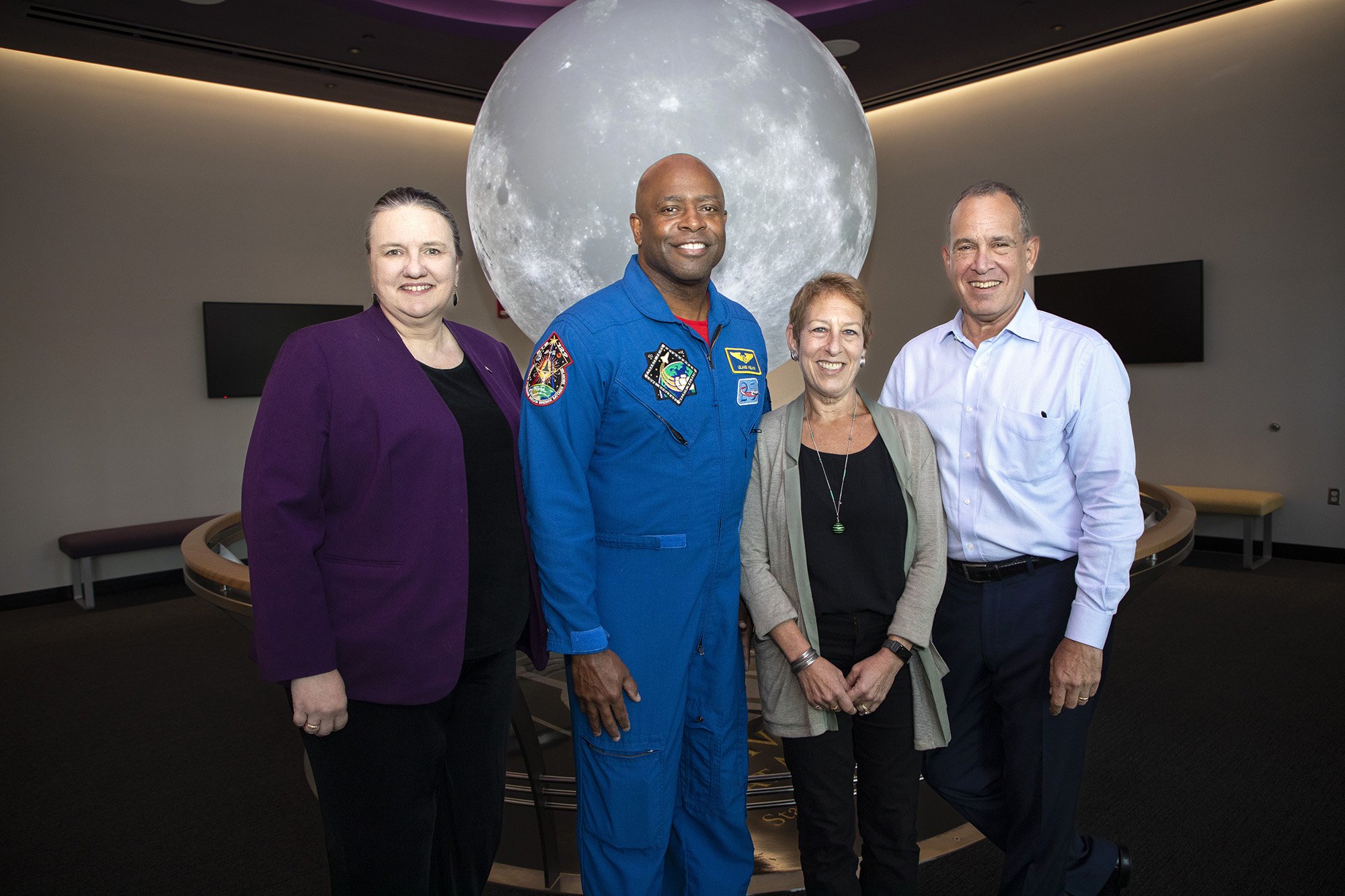 CNSE Dean Michele J. Grimm, Former NASA Astronaut Leland Melvin, Caryn Bunshaft '82, and Albert Bunshaft '80 have their photo taken in the Sphere Room at UAlbany's ETEC.