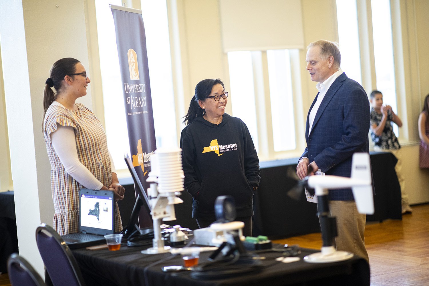 Researchers from the New York State Mesonet talk with ASRC Research Associate Scott Miller at the senior faculty recognition event.