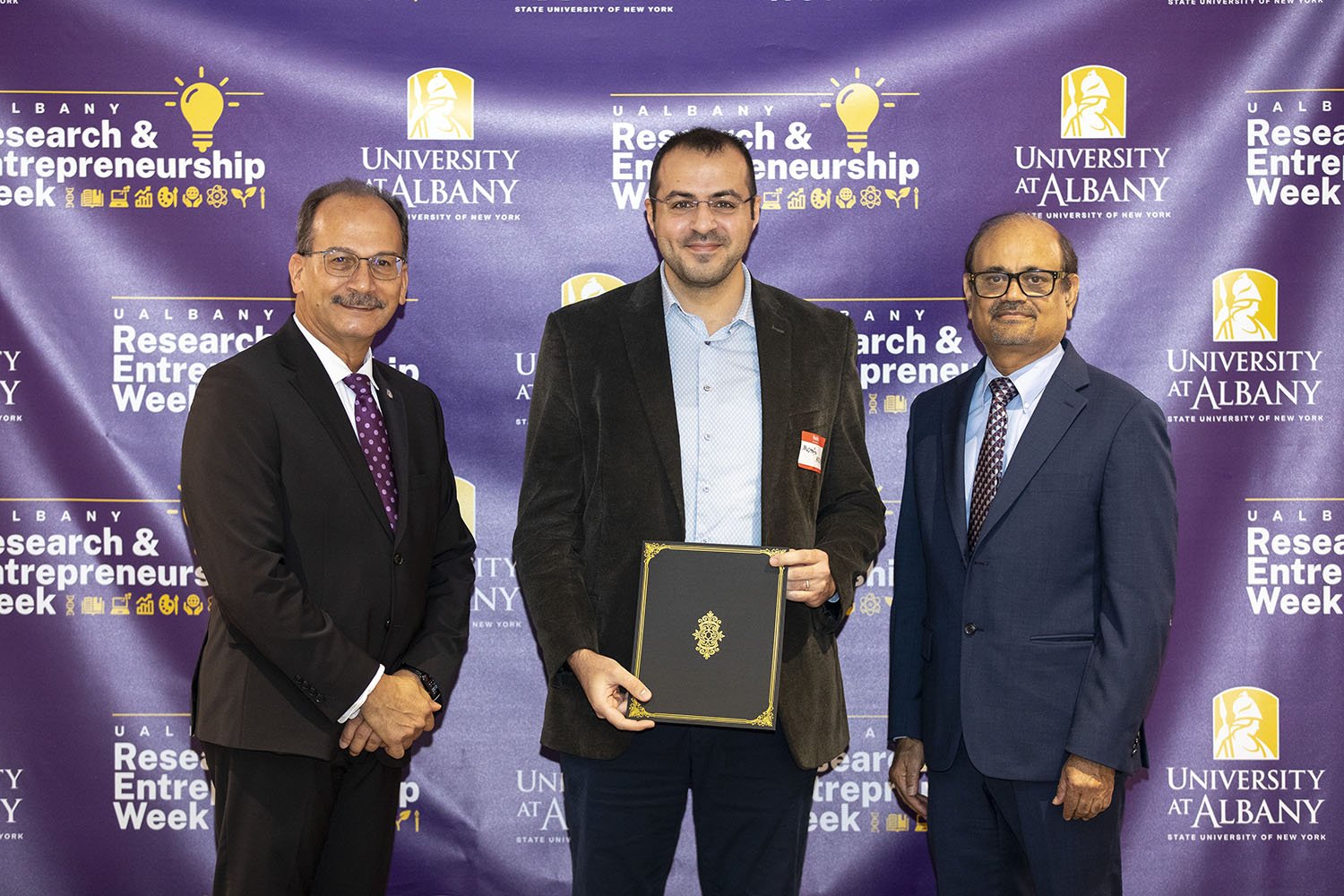 Mustafa Aksoy, CNSE, with UAlbany President Havidán Rodríguez and Vice President for Research and Economic Development Thenkurussi “Kesh” Kesavadas.