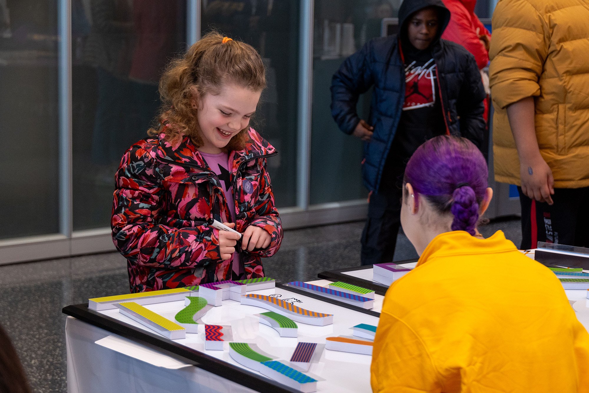 A young girl takes part in a science experiment at UAlbany's STEM & Nanotechnology Family Day at ETEC.